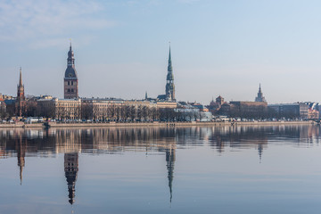Fototapeta premium Cityscape of Riga Latvia with Reflections on a Quiet Still River