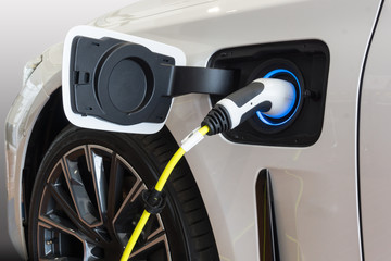Power supply connect to electric car for add charge to the battery. Charging re technology industry...