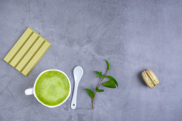 matcha latte with leaf, green chocolate, macaroon