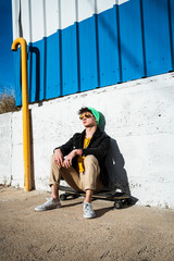 Guy with skateboard on the street dressed modern © Rafa