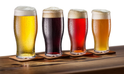 Collection of four types of different beer in glasses isolated on a white background.File contains a clipping path.