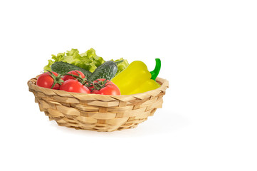 fresh vegetables in wicker basket isolated on white background