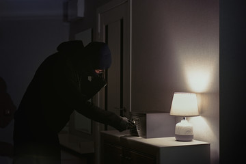 Burglar tries to find the combination code of a safe   