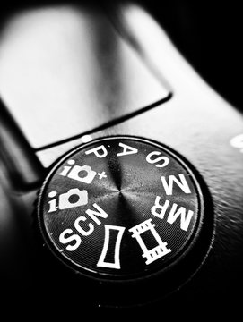 Mode selection button pasm on mirrorless dslr camera close up view