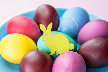 Colorful Easter eggs as an attribute of Easter celebration. Pink background.