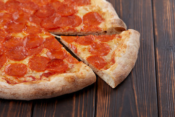 tasty pizza on the wooden background