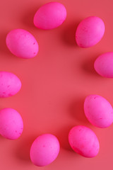 vertical frame of Easter Eggs On Pink Background, flat lay