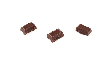 Close-up pieces of chocolate bar with filling isolated on white background.