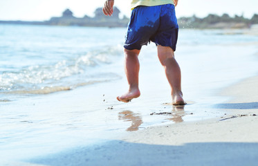 Child legs on sand texture.