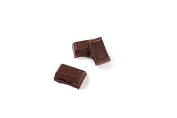 Close-up pieces of chocolate bar with filling isolated on white background.