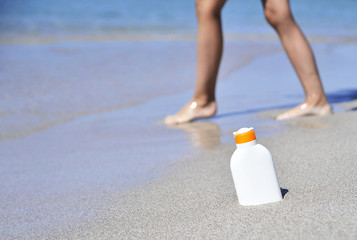 Female legs on the beach.
