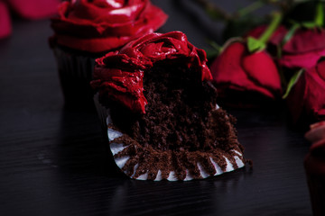 bitten chocolate cupcake with rose flower