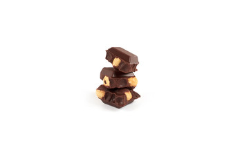 Chocolate pieces with nuts isolated on white background