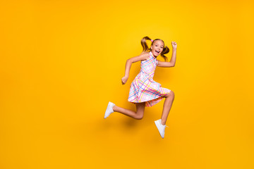 Full size profile side photo of cheerful crazy funny small kid girl jump run after spring time...