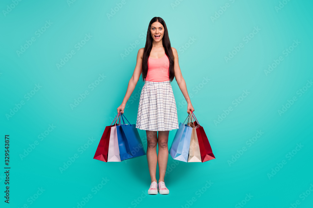 Poster Full length photo energetic astonished girl shopping center client hold bags enjoy unbelievable discounts scream wow omg wear pink singlet checkered gumshoes isolated teal color background