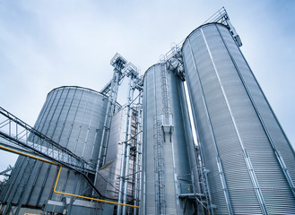 Silos for storage of grain, silo roof close-up. Warehouse of wheat cereals. View from bottom.