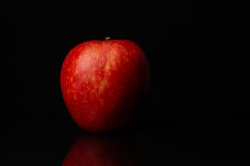 Image of Argentinian apple on black background.