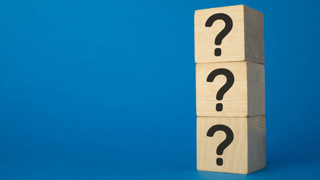 question mark shown on three wooden cubes on a blue background