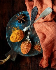 Mix of spices on a dark wooden background.
