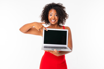 Handsome woman with dark hair shows a new tablet and smiles, picture isolated on white background