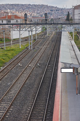 Naklejka premium An empty railway station with city view in background