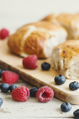 Fresh blueberry and raspberry served with hot cross buns, traditional Easter pastry. Festive season