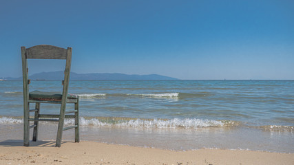 Fototapeta na wymiar broken chair isolated at the beach
