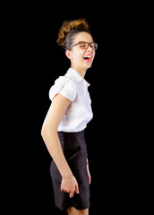 Cheerful happy young woman in glasses laughing out loud at humorous comedy hilarious silly joke, happy brunette girl screaming with sincere laughter isolated on white black studio background