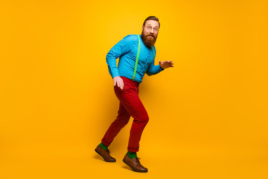 Full length body size view of his he nice attractive cheerful cheery funky guy sneaking walking tiptoe isolated over bright vivid shine vibrant yellow color background