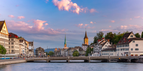 Fototapeta na wymiar Panoramic view of famous Fraumunster and Church of St Peter and river Limmat at sunrise in Old Town of Zurich, the largest city in Switzerland