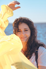Portrait of beautiful brown-haired woman on background of sea