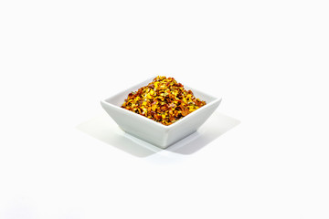 Hot seasoning in plate isolated on white background. Mix of different spices and sea salt. Traditional ingredient for cooking Italian food