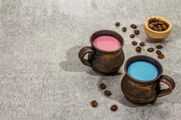 Fototapeta na wymiar Trendy drink blue and pink latte. Lavender or spirulina and rose, beetroot or raspberry coffee. Stone concrete background