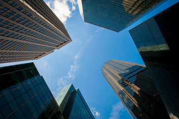 Abstract blue sky view of modern glass and steel skyscrapers from below in Midtown Manhattan, New...