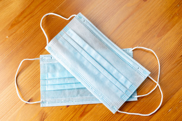 2 medical masks on a wooden background. virus and allergy protection