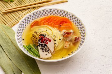 Korean noodle soup with smoked chicken and vegetables. Spring spicy dish for healthy meal