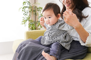 家でリラックスをするお母さんと赤ちゃん