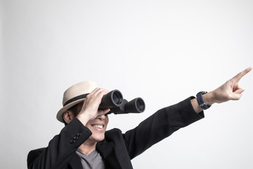 Fototapeta premium Adult Asian man point and look with binoculars.