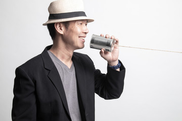 Adult Asian man  with tin can phone.