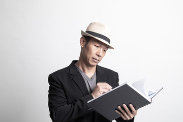 Adult Asian man with a book.