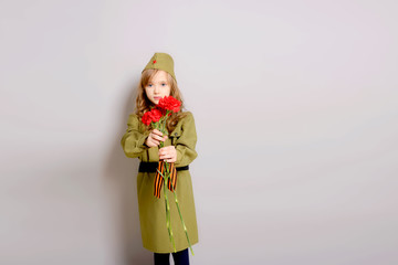 9 MAY. Beautiful little blonde girl kid with red carnation flowers for veterans. Victory Day. Memorial day. We remember! We are proud! Gift to war veterans.