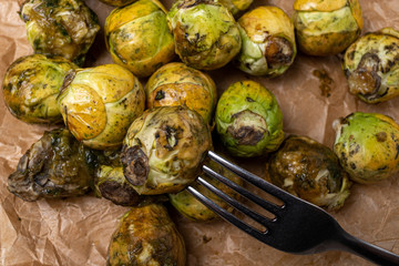 Food wasting. Spoiled vegetables with a fork