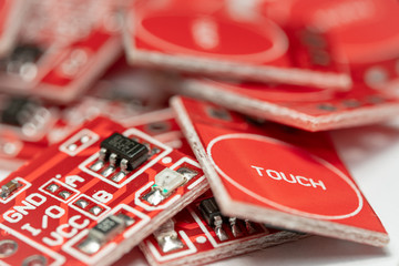Macro Photo of a pile of Red capacitive touch sensor modules (Arduino Project)