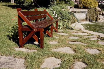 Retro style wooden bank in the backyard garden