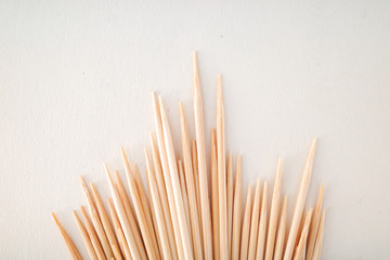 Toothpicks on a white background - obrazy, fototapety, plakaty