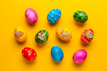 Bright easter eggs with bunny (rabbit) on yellow background. Retro colorful spring decoration.