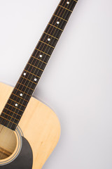 Top view of acoustic guitar on white background