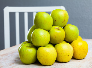 Many of ripe green apples on the wooden table
