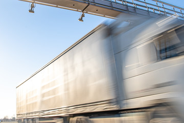 Fototapeta premium truck passing through a toll gate on a highway toll roads
