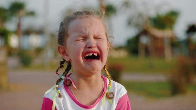 Hardly crying little girl, tears streaming down her face, real emotions